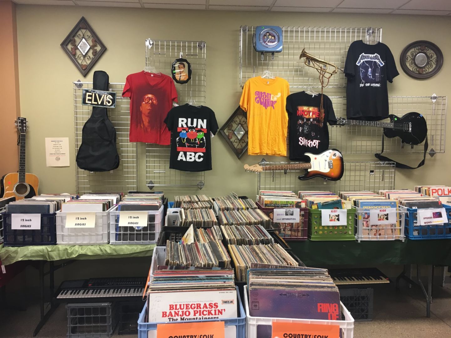 A display of records and rock bank tee-shirts.